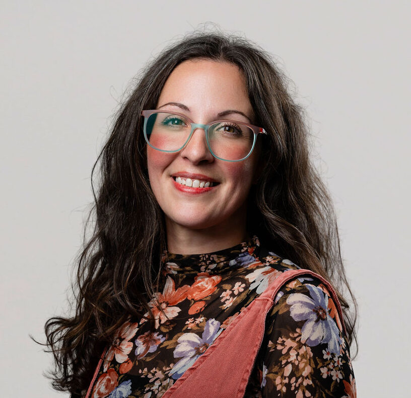 Administrative team member, Sky Pasinski, smiling into the camera for a headshot.
