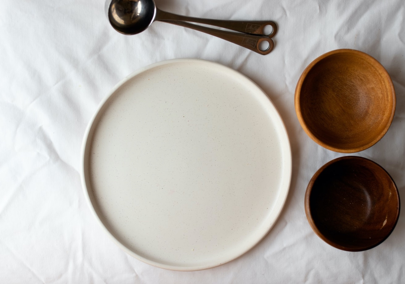 A top down view of an empty plate and bowls. This could represent the appetite changes that eating disorder treatment in Hershey, PA can offer support with. Learn more about online therapy for eating disorders in Allentown, PA by contacting a disordered eating therapist in Hershey, PA today! 17033