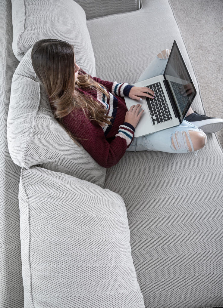 A top down view of a person typing on their laptop while sitting on a sofa. Online anxiety therapy in Pennsylvania can offer support from the comfort of home. Learn more about our service form an anxiety therapist in Pennsylvania, and learn how online therapy for anxiety can support you! 17033