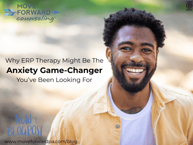 A black man in a white t -shirt and light yellow button down shirt over it smiling while standing outside in the sunshine thinking about how ERP therapy might help manage his anxiety