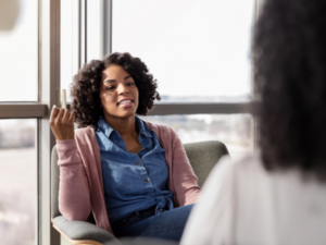 A therapist talking to a mother in her office about types of perinatal and maternal mental health therapy
